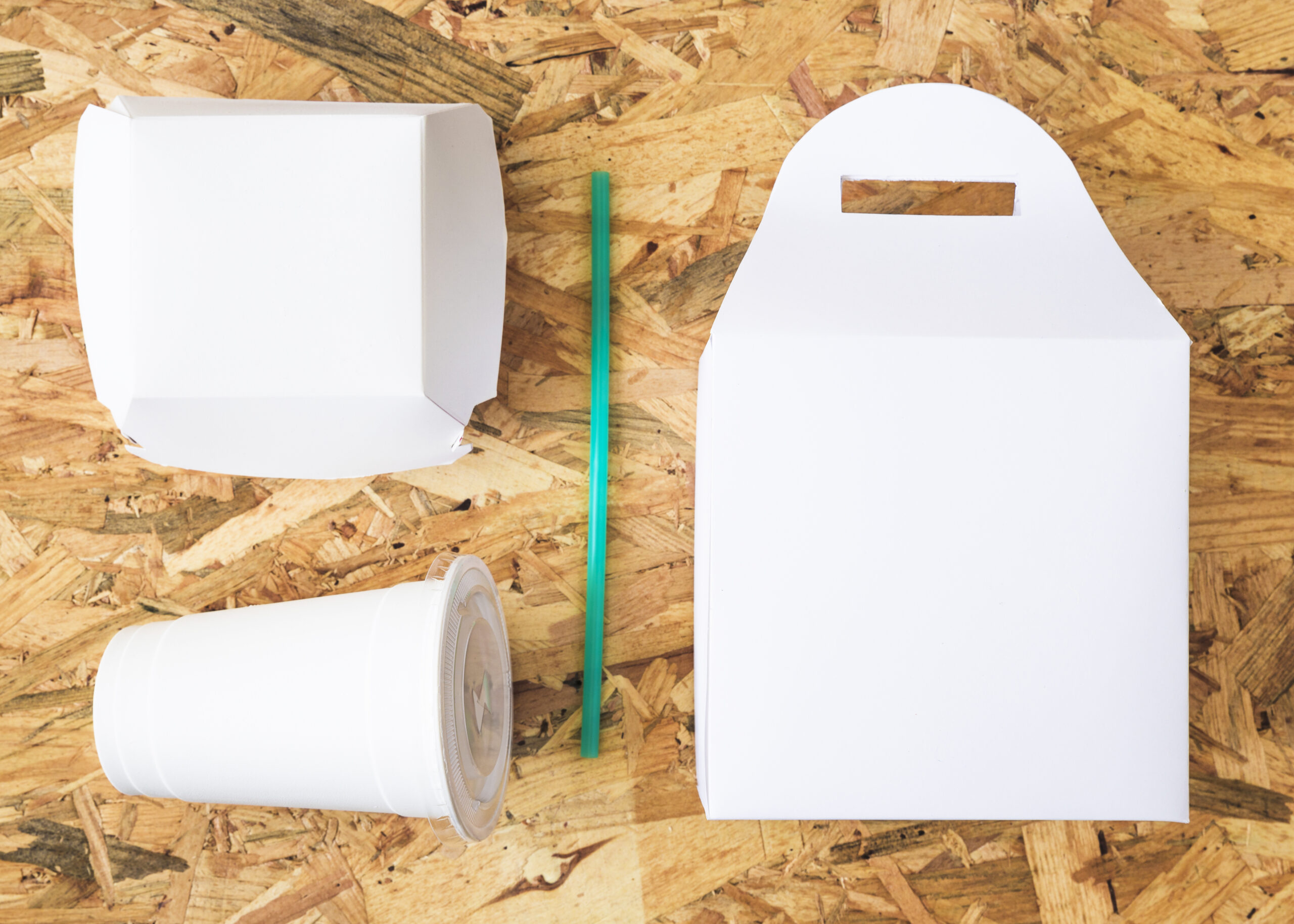 white-takeaway-food-with-turquoise-drinking-straw-wooden-background